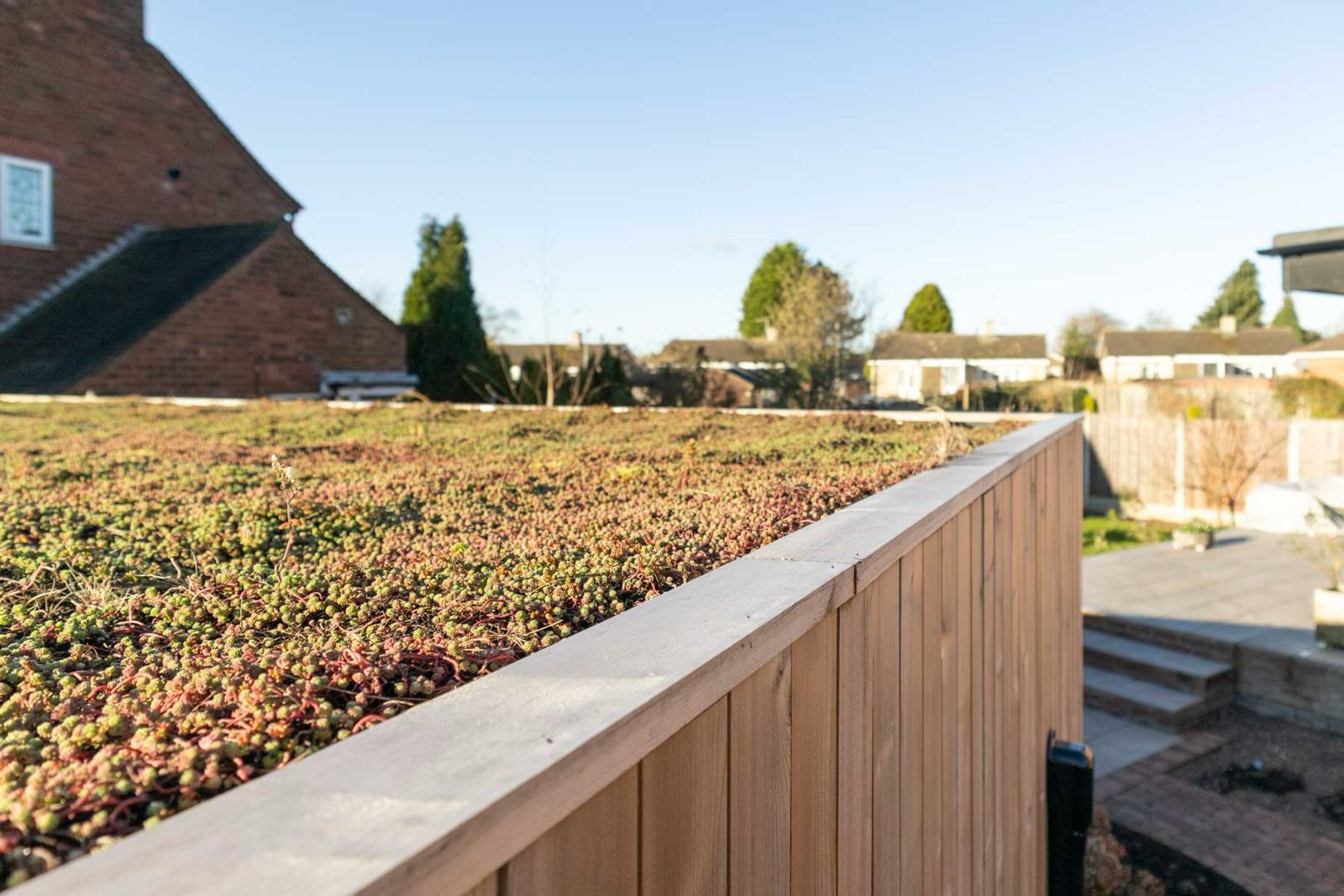 Inside one of our premium sedum roof garden pods, showcasing a bright, modern office interior with vertical wood slats and a minimalist desk setup.