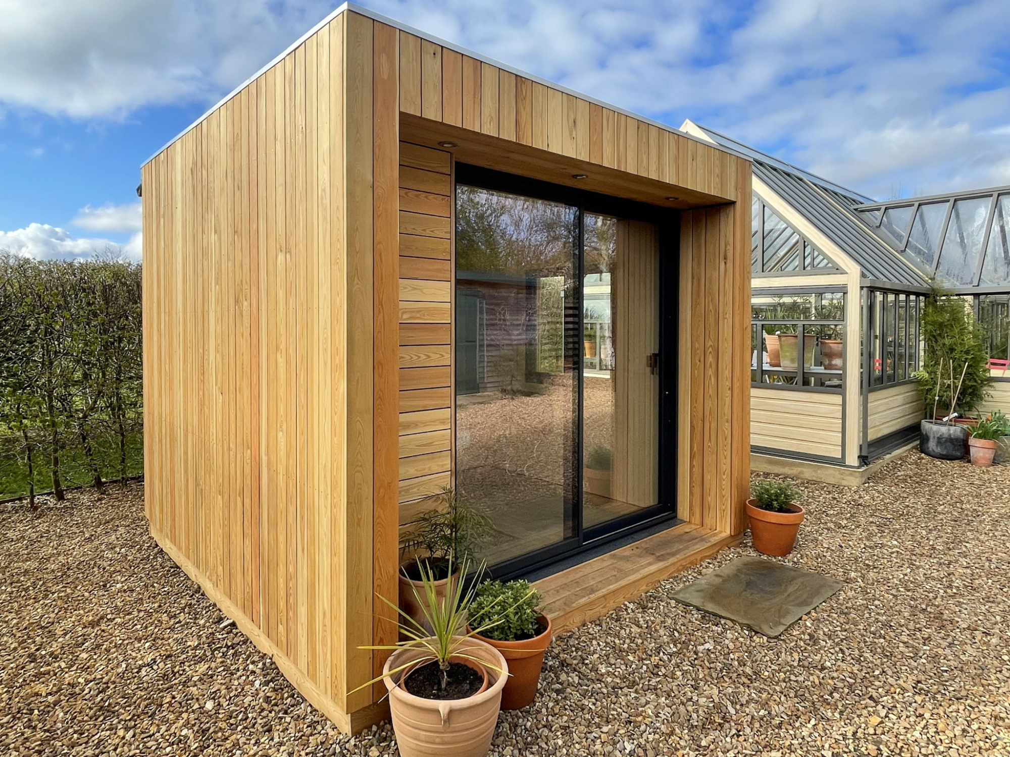 A premium cedar office pod on a gravel foundation, featuring a compact footprint that often qualifies for exemption under a standard Colorado backyard office permit.