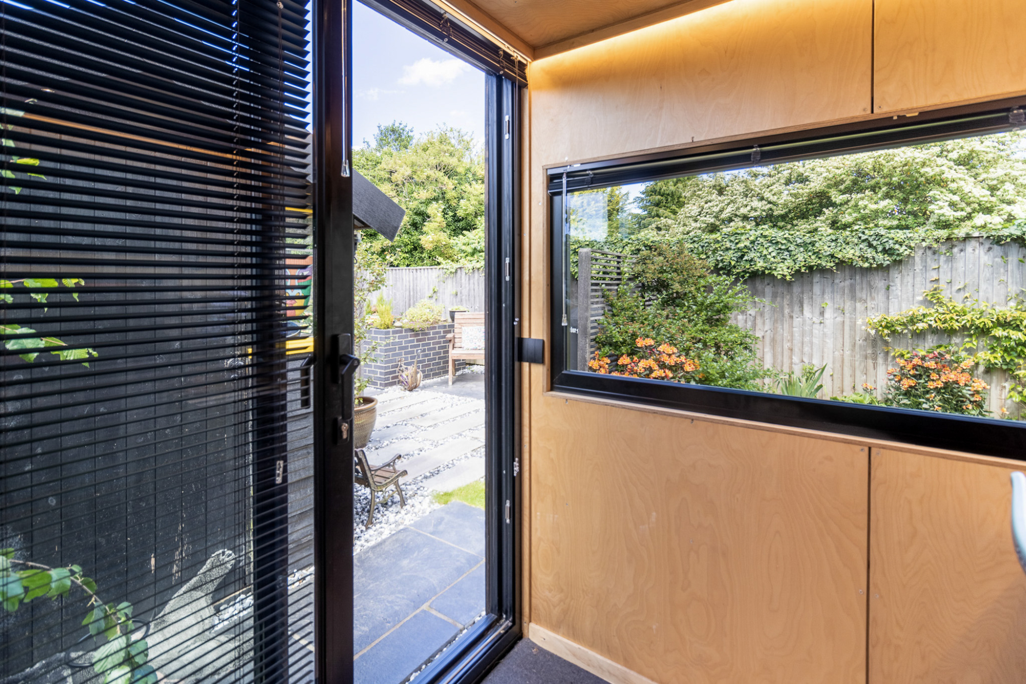 Looking out into a yard from a premium detached workspace designed to match local setback requirements and clear a Colorado backyard office permit.