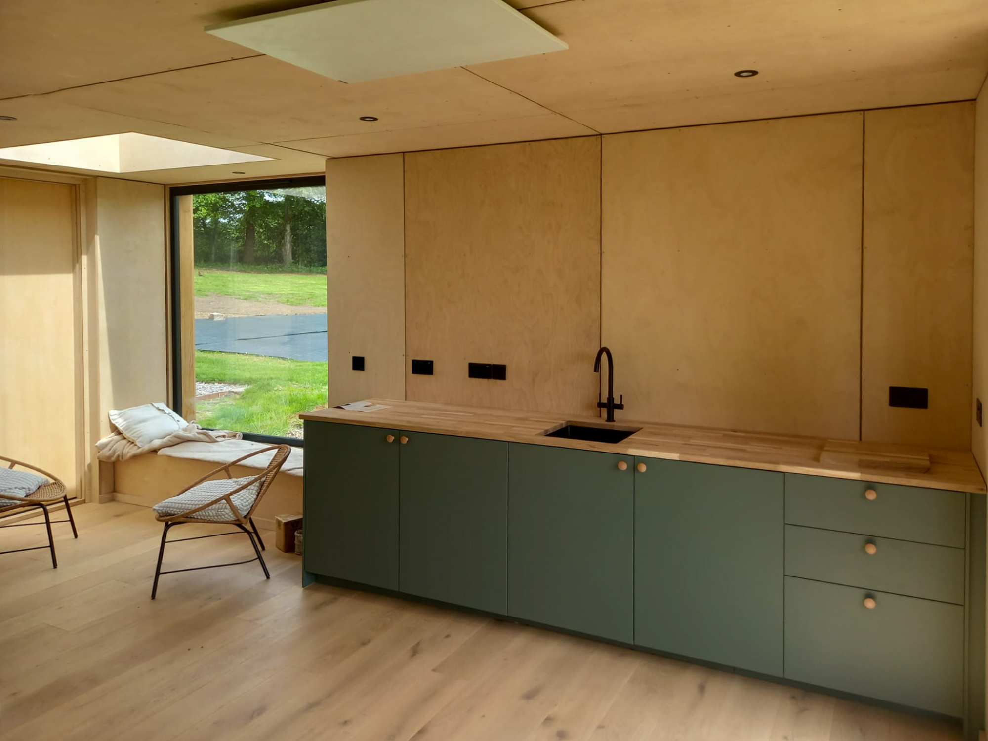 Integrated living area inside a luxury garden annex pod, designed as a self-contained guest suite or multi-generational living space.